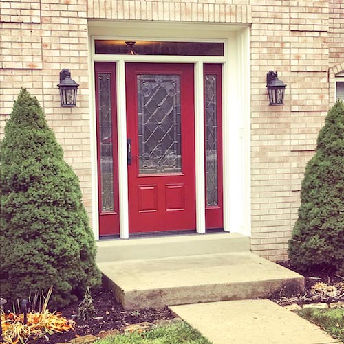 red front door with window and white frame