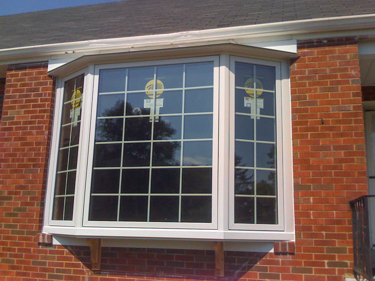 white bay window on brick house