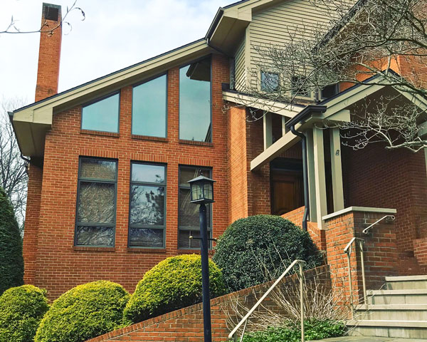 Large living room windows on brick house