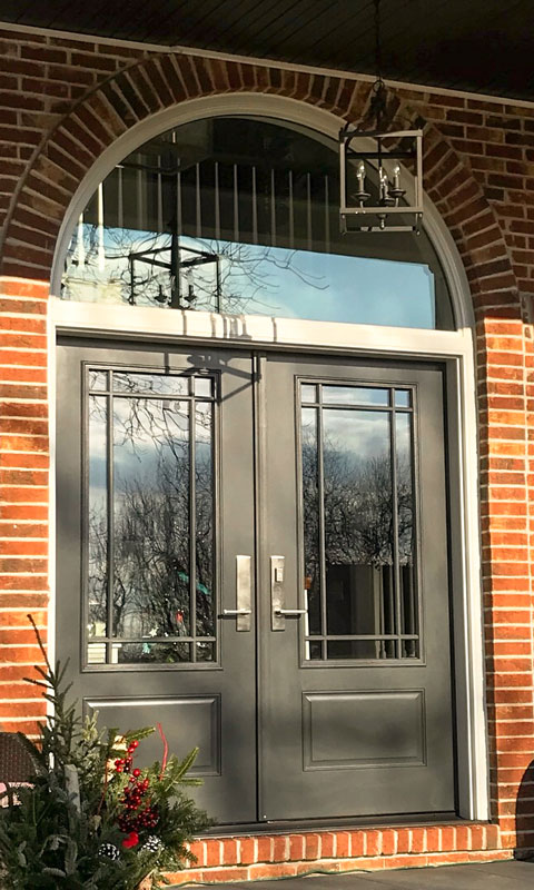 Black front door on brick house